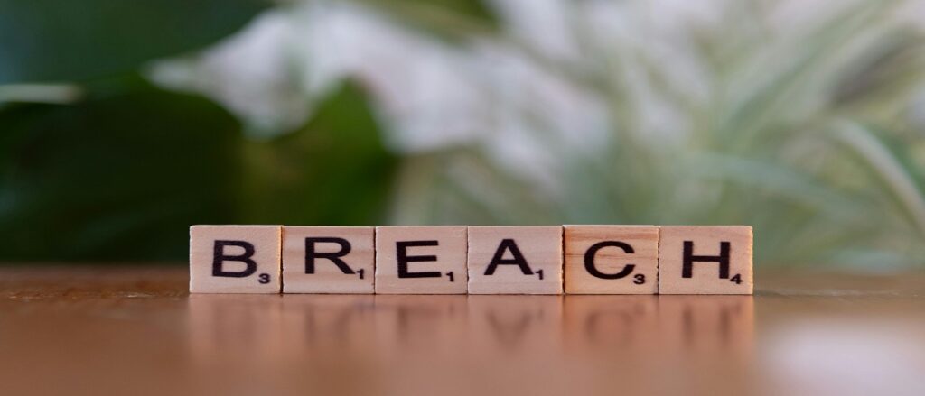 Picture of scrabble letters spelling breach associated with blog on gross negligence redefined