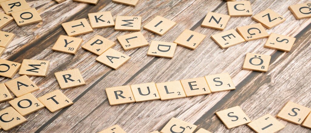 Picture of scrabble board with rules associated with blog on Daubert standard