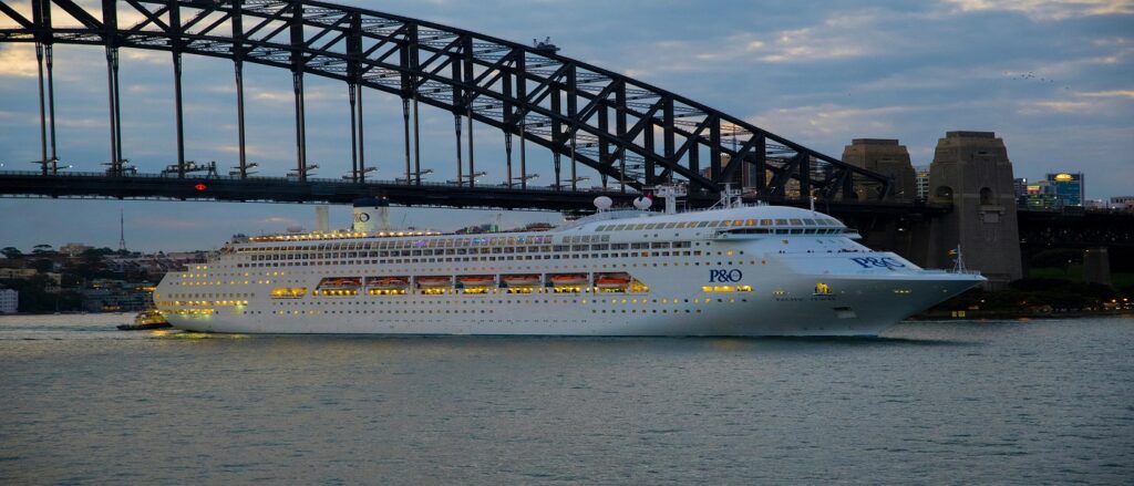 Picture of cruise ship passing under bridge associated with blog on cruise ship personal injury