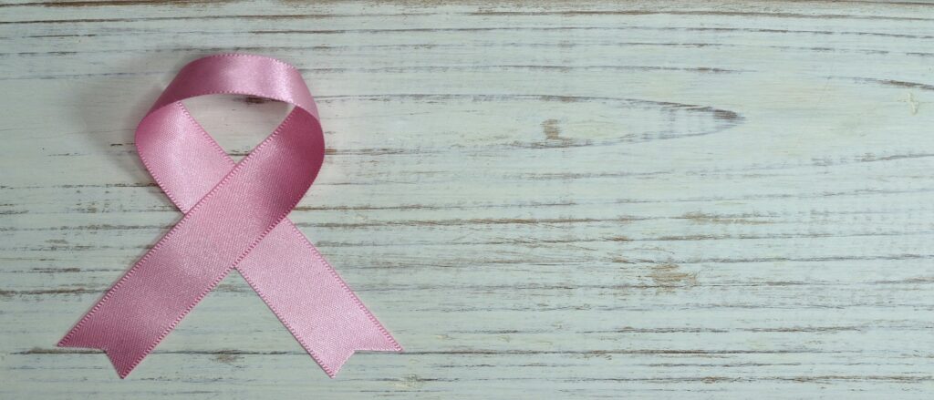 Picture of pink ribbon on medical record associated with blog on medical malpractice breast cancer