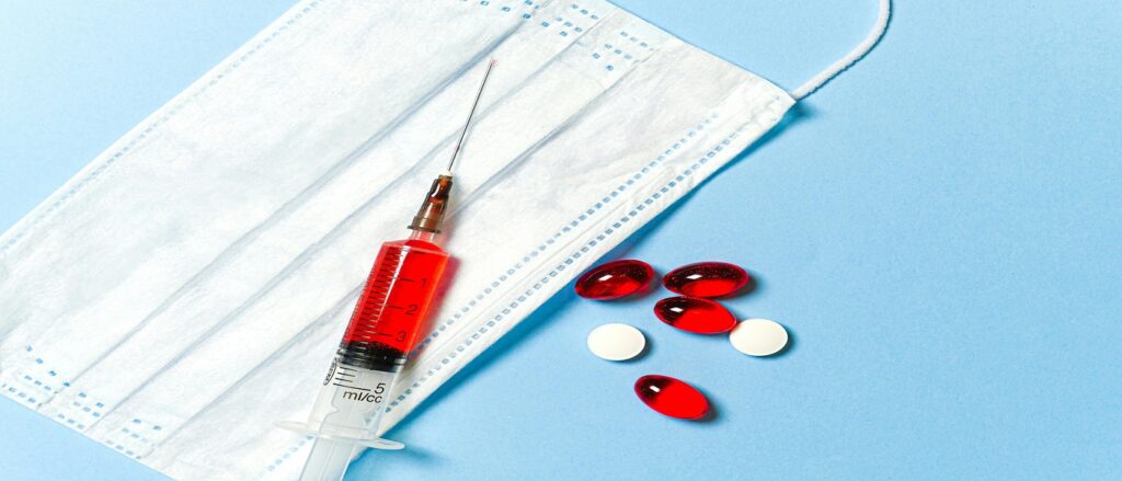 Picture of needle and pills associated with blog on injection malpractice