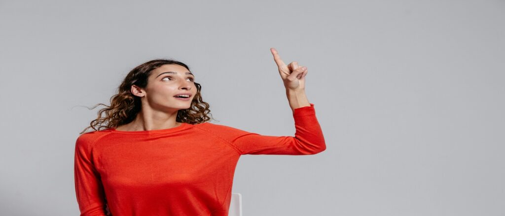 Picture of woman pointing up suggesting rates are going up associated with blog on personal injury interest awards
