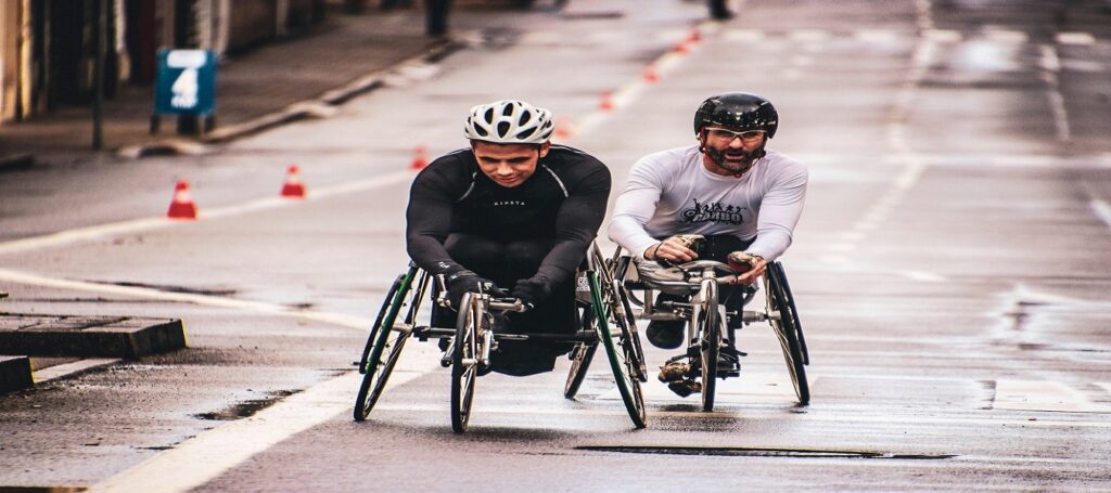Picture of two men racing in wheelchairs associated with blog on impairment ratings personal injury