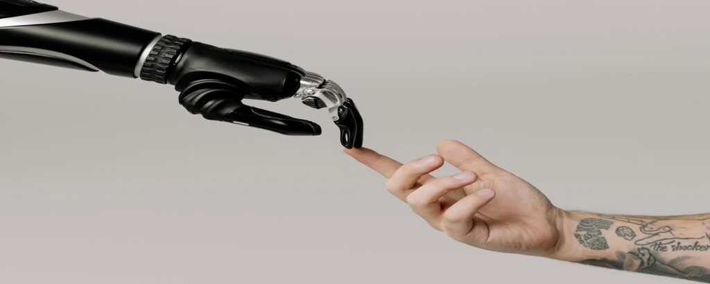 Picture of robot hand and human hand associated with blog on personal injury biomechanical experts