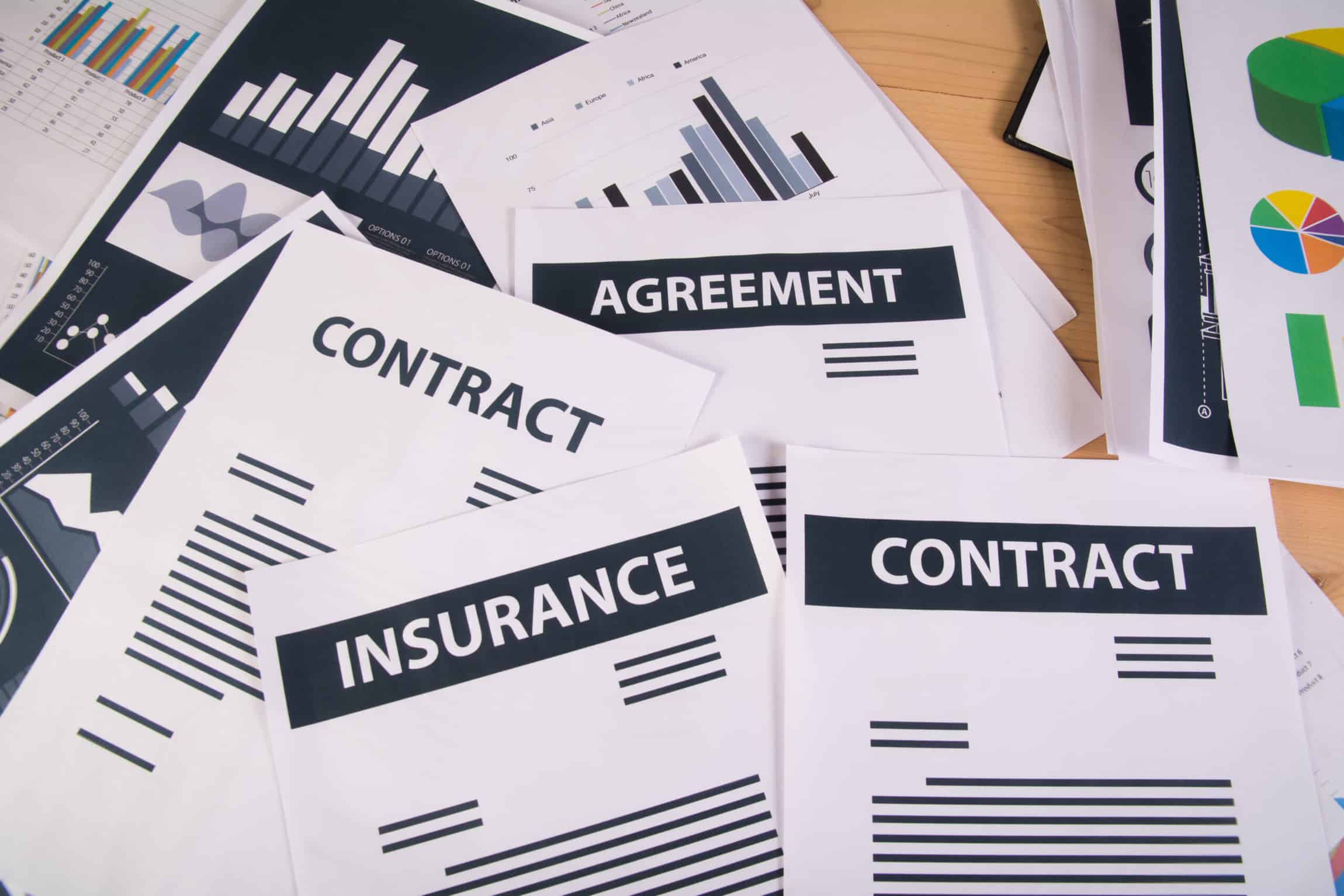 insurance contracts all over desk