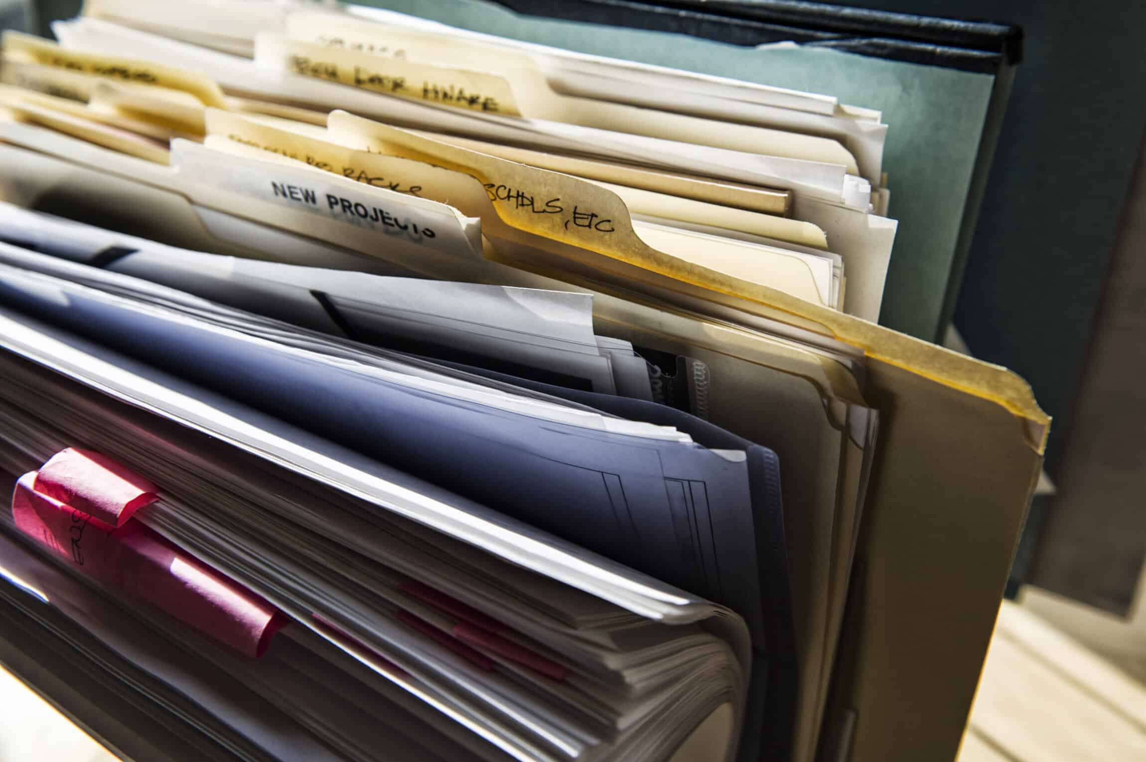 Close-up of files and file folders on a desk top in an office.