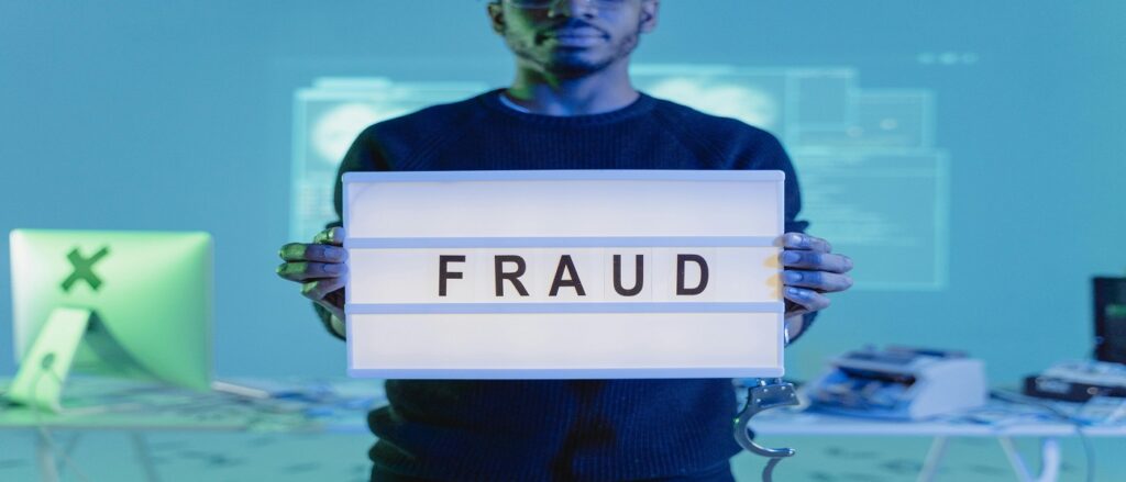 Picture of person holding sign saying fraud associated with blog on fraud in medical malpractice
