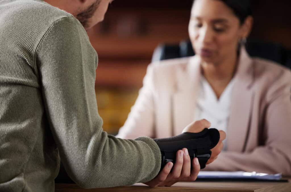 Men with hand injury talking to personal injury lawyer