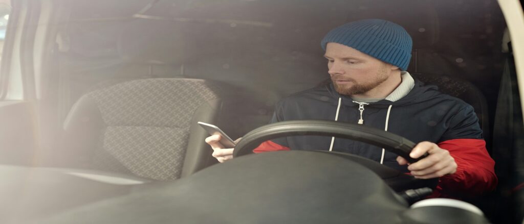 Picture of driver using cell phone while driving associated with blog on distracted driving