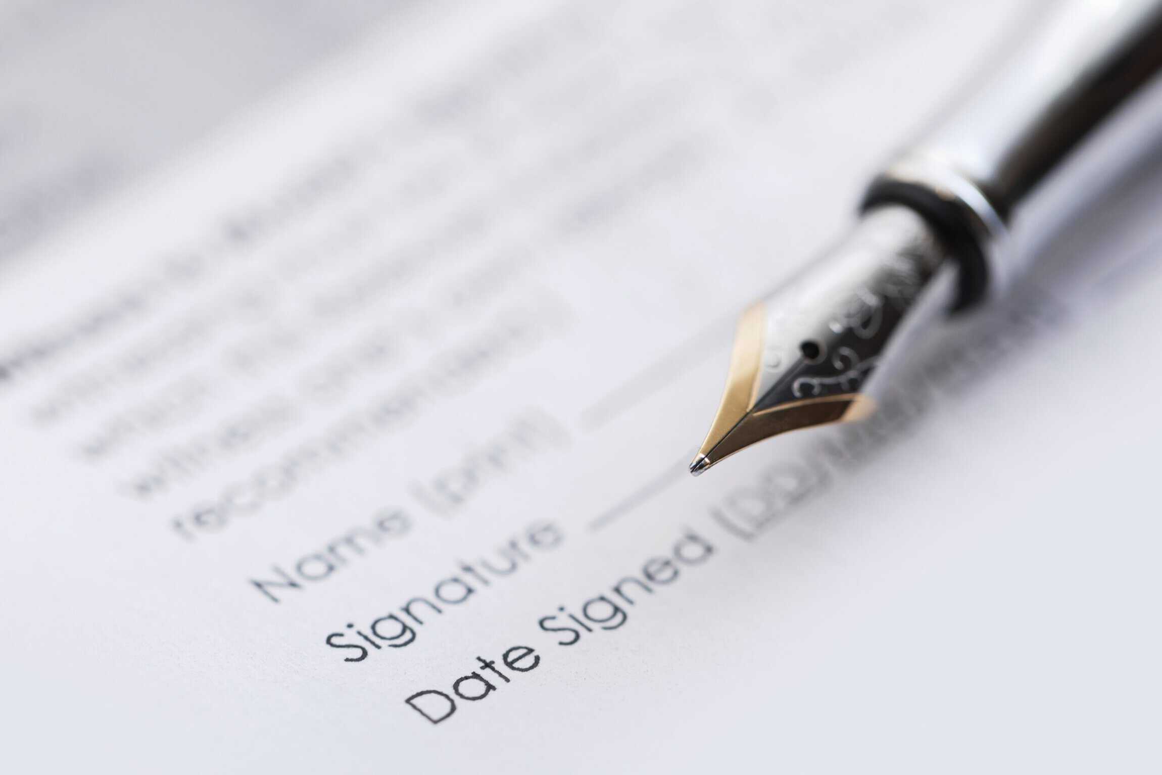 close up of a pen on a legal document
