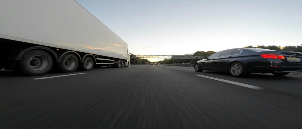 Picture of truck and car on highway associated with blog on right lawyer truck accident