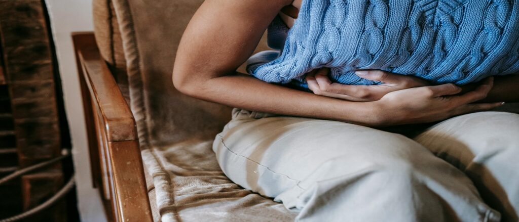 Picture of person holding their stomach associated with blog on esophageal reflux medical malpractice