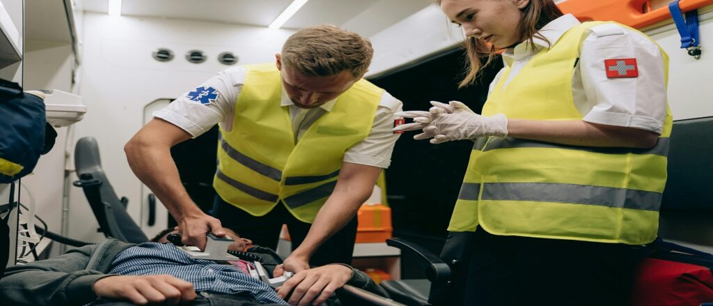 Picture of health care providers rendering emergency care associated with blog on medical malpractice causation plus defenses