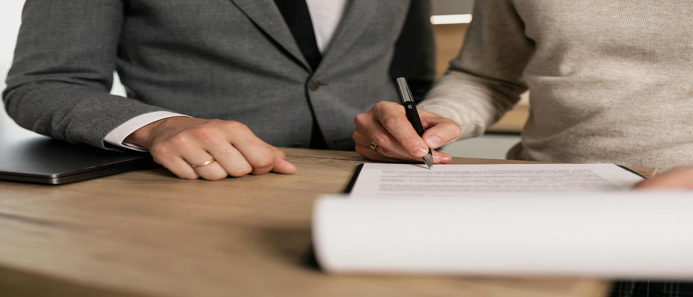 Picture of person signing contract